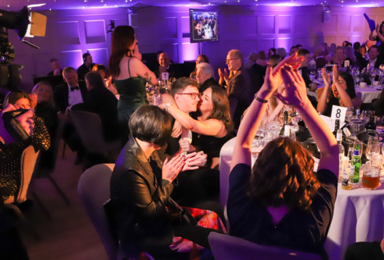 People sat around a table at Fetcher Dog's annual charity ball celebrating the events success