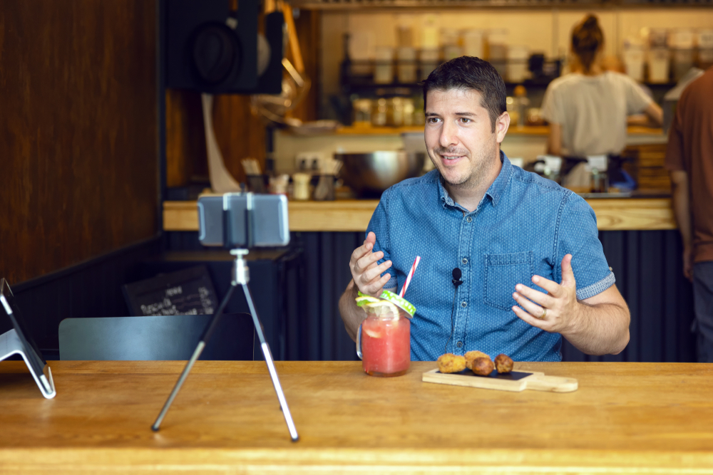 Man filming video content for social media on phone