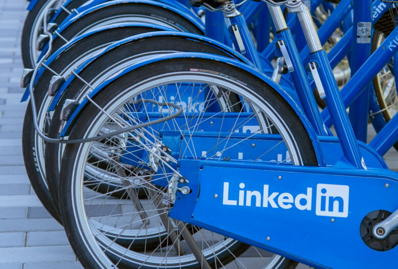 A row of blue LinkedIn bicycles parked side by side.
